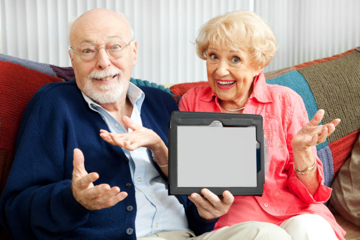 older couple confused holding tablet